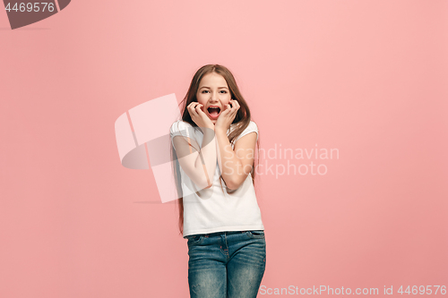 Image of Beautiful teen girl looking suprised isolated on pink