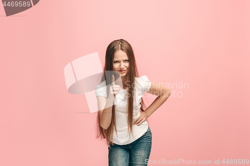 Image of Beautiful female half-length portrait on pink studio backgroud. The young emotional teen girl