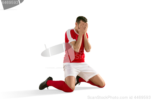 Image of unhappy soccer or football player with palm on his face