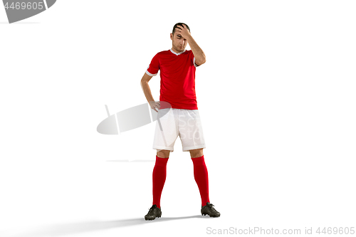 Image of unhappy soccer or football player with palm on his face