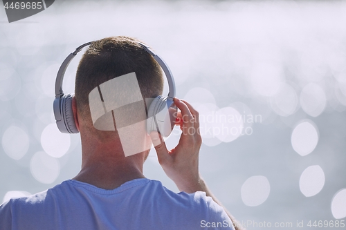 Image of Young man with headphones listening