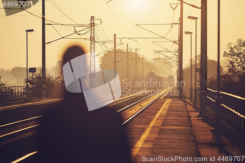 Image of Man waiting at railroad station