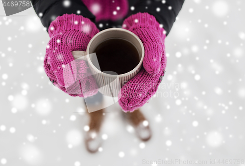 Image of close up of woman with tea mug outdoors in winter