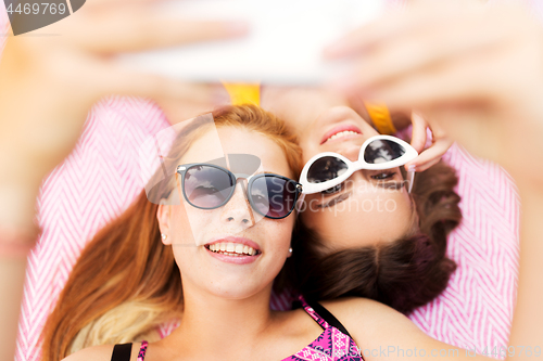 Image of teenage girls in sunglasses taking selfie