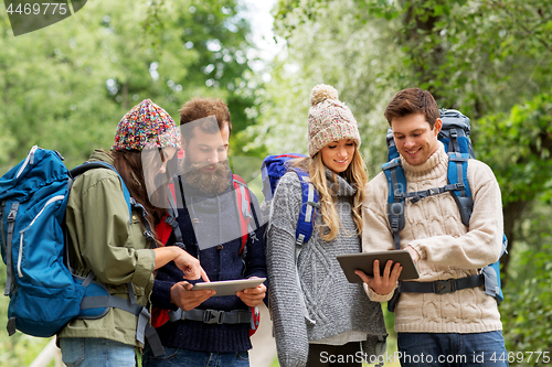 Image of friends or travelers with backpacks and tablet pc