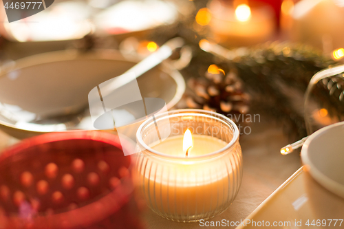 Image of candle burning on christmas table