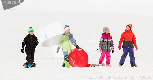 Image of happy little kids with sleds in winter