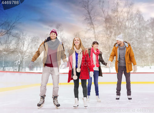 Image of happy friends on outdoor skating rink