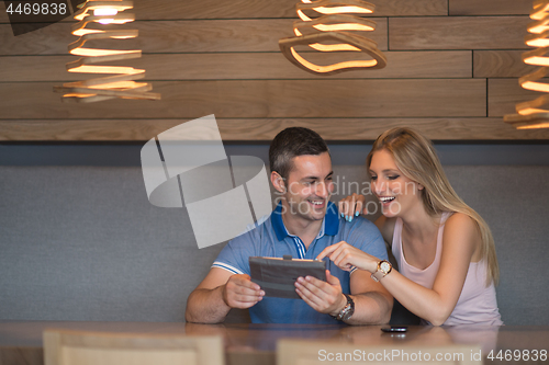 Image of couple using tablet at home