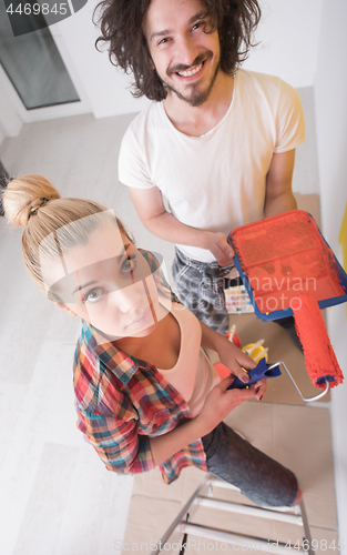 Image of couple painting interior wall