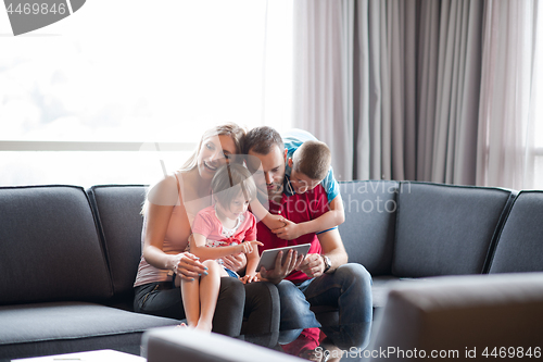 Image of happy young couple spending time with kids