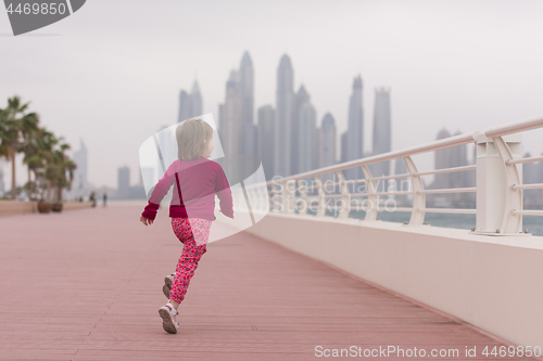 Image of cute little girl on the promenade by the sea