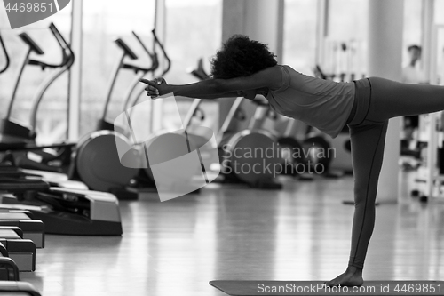 Image of african american woman exercise yoga in gym