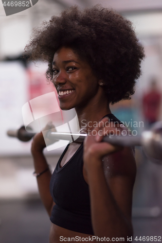 Image of black woman lifting empty bar