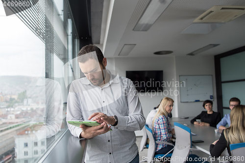 Image of Businessman Using Tablet In Office Building by window