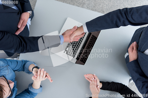 Image of cloasing the deal in modern office interior top view