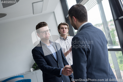 Image of cloasing the deal in modern office interior