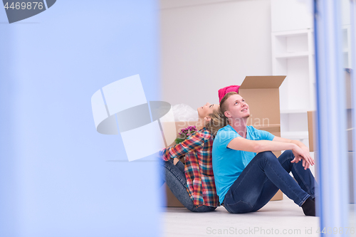 Image of young couple moving  in new house
