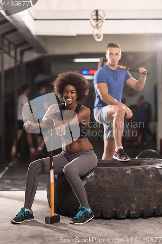 Image of multiethnic couple after workout with hammer