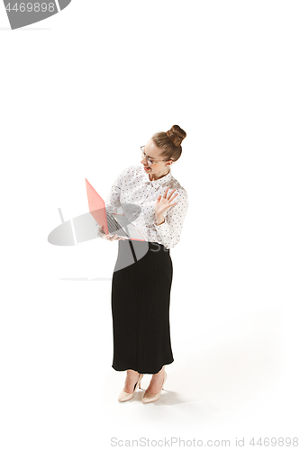 Image of Full length portrait of a smiling female teacher holding a laptop isolated against white background