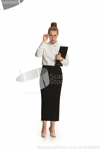 Image of Full length portrait of a surprised female teacher holding a folder isolated against white background