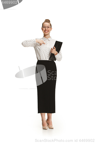 Image of Full length portrait of a female teacher holding a folder isolated against white background