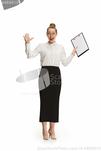 Image of Full length portrait of a surprised female teacher holding a folder isolated against white background