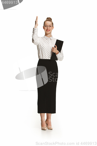 Image of Full length portrait of a female teacher holding a folder isolated against white background