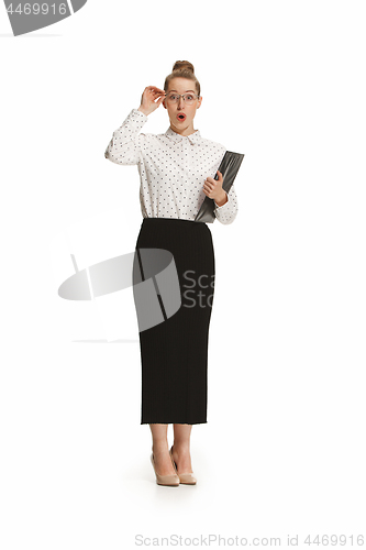 Image of Full length portrait of a surprised female teacher holding a folder isolated against white background