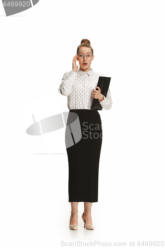 Image of Full length portrait of a surprised female teacher holding a folder isolated against white background