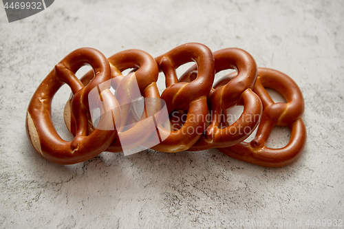 Image of Row of fresh baked brown salty pretzel bread