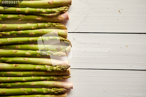 Image of Above view of flat-lay organic raw uncooked green asparagus