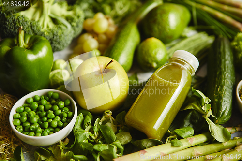 Image of Green antioxidant organic vegetables, fruits and herbs placed on gray stone