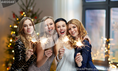 Image of happy young women dancing at night club disco