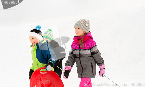 Image of happy little kids with sleds in winter