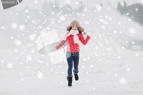 Image of happy woman in winter fur hat outdoors