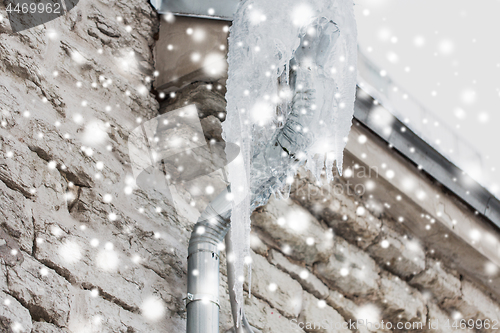 Image of icicles hanging from building drainpipe