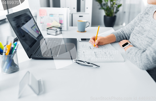 Image of web designer working on user interface at office