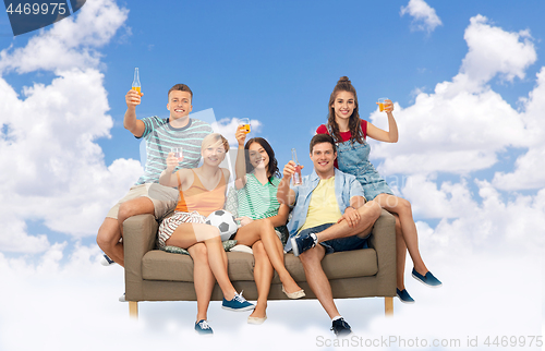 Image of friends or soccer fans with ball and drinks in sky