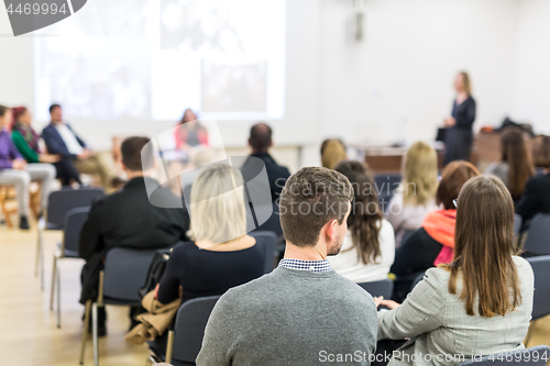 Image of Woman giving presentation in lecture hall at university.