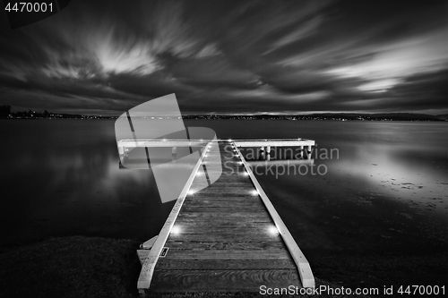 Image of Timber jetty with moody skies at night