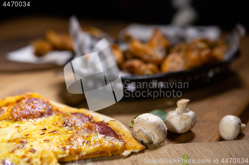 Image of Rustic bistro pub food pizza and basket chicken wings