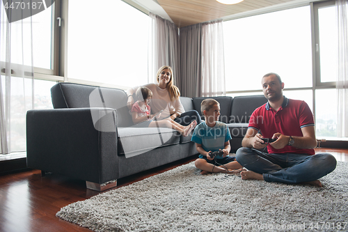 Image of Happy family playing a video game