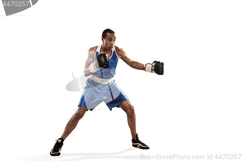 Image of Sporty man during boxing exercise making hit. Photo of boxer on white background