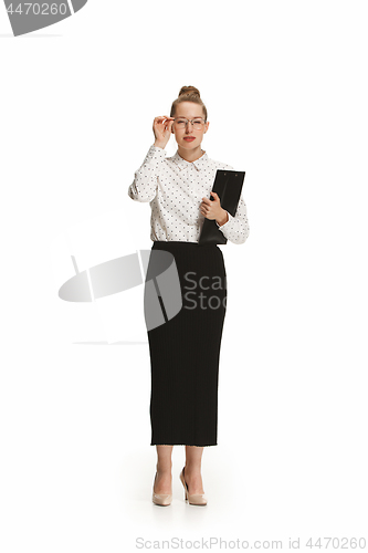 Image of Full length portrait of a smiling female teacher holding a folder isolated against white background