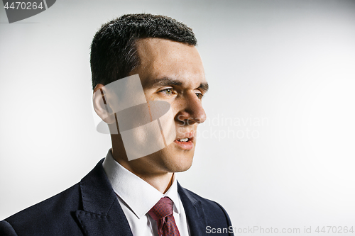 Image of Three-quarter portrait of a businessman with disgust face. Confident professional with piercing look in the foreground of the camera.