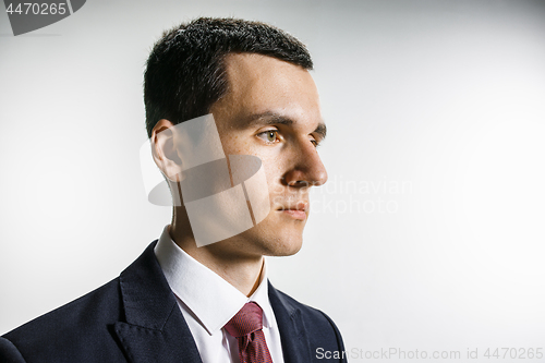 Image of Three-quarter portrait of a businessman with very serious face. Confident professional with piercing look in the foreground of the camera.