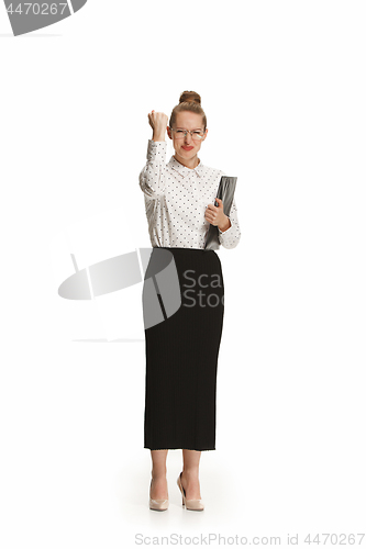 Image of Full length portrait of a smiling female teacher holding a folder isolated against white background