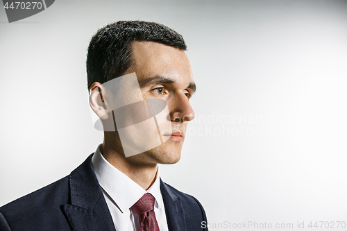 Image of Three-quarter portrait of a businessman with very serious face. Confident professional with piercing look in the foreground of the camera.