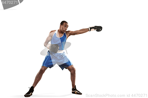 Image of Sporty man during boxing exercise making hit. Photo of boxer on white background